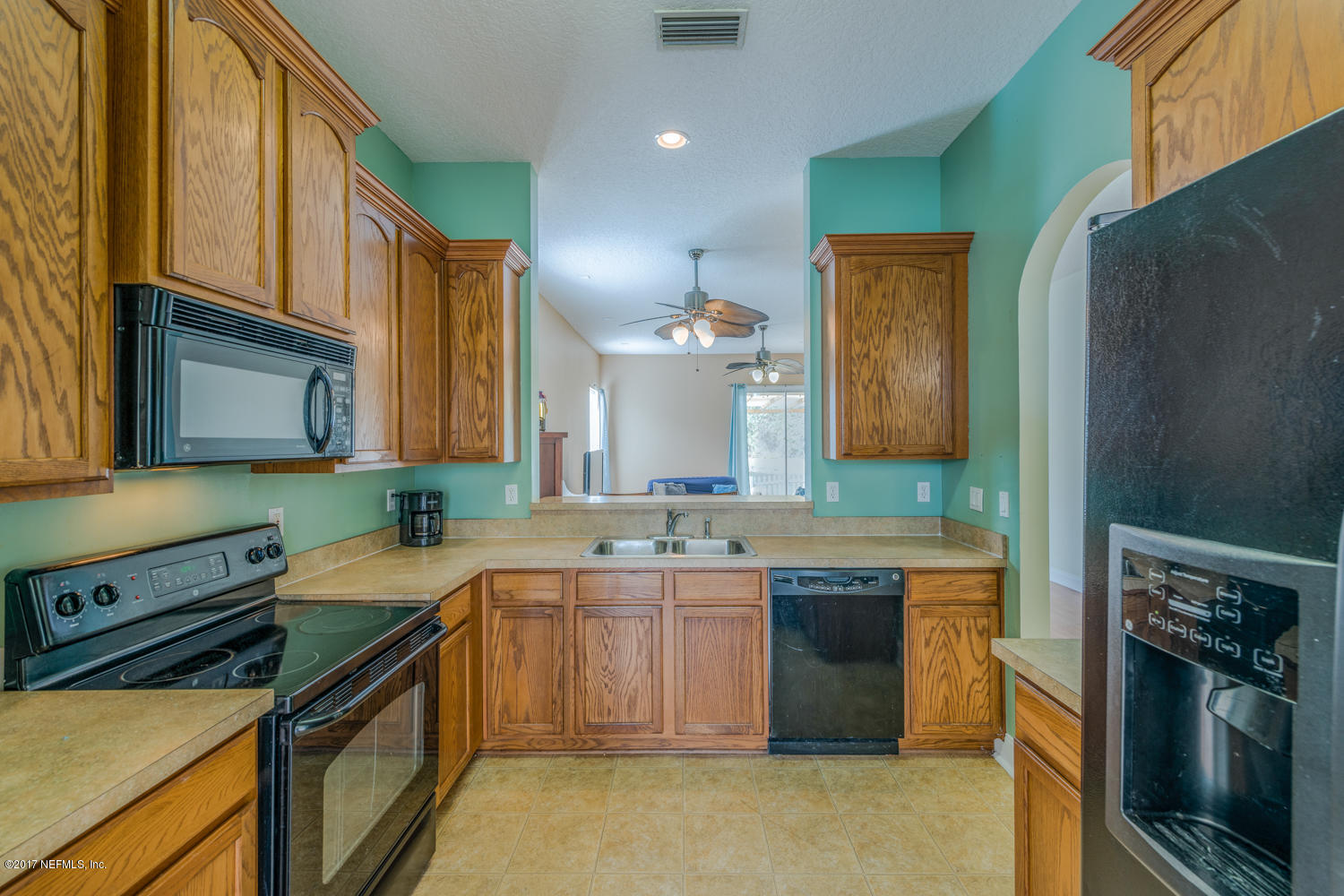 9170 Raptor Drive Jacksonville, FL 32221 - Photo 13 of 31 a kitchen with a sink stove and refrigerator