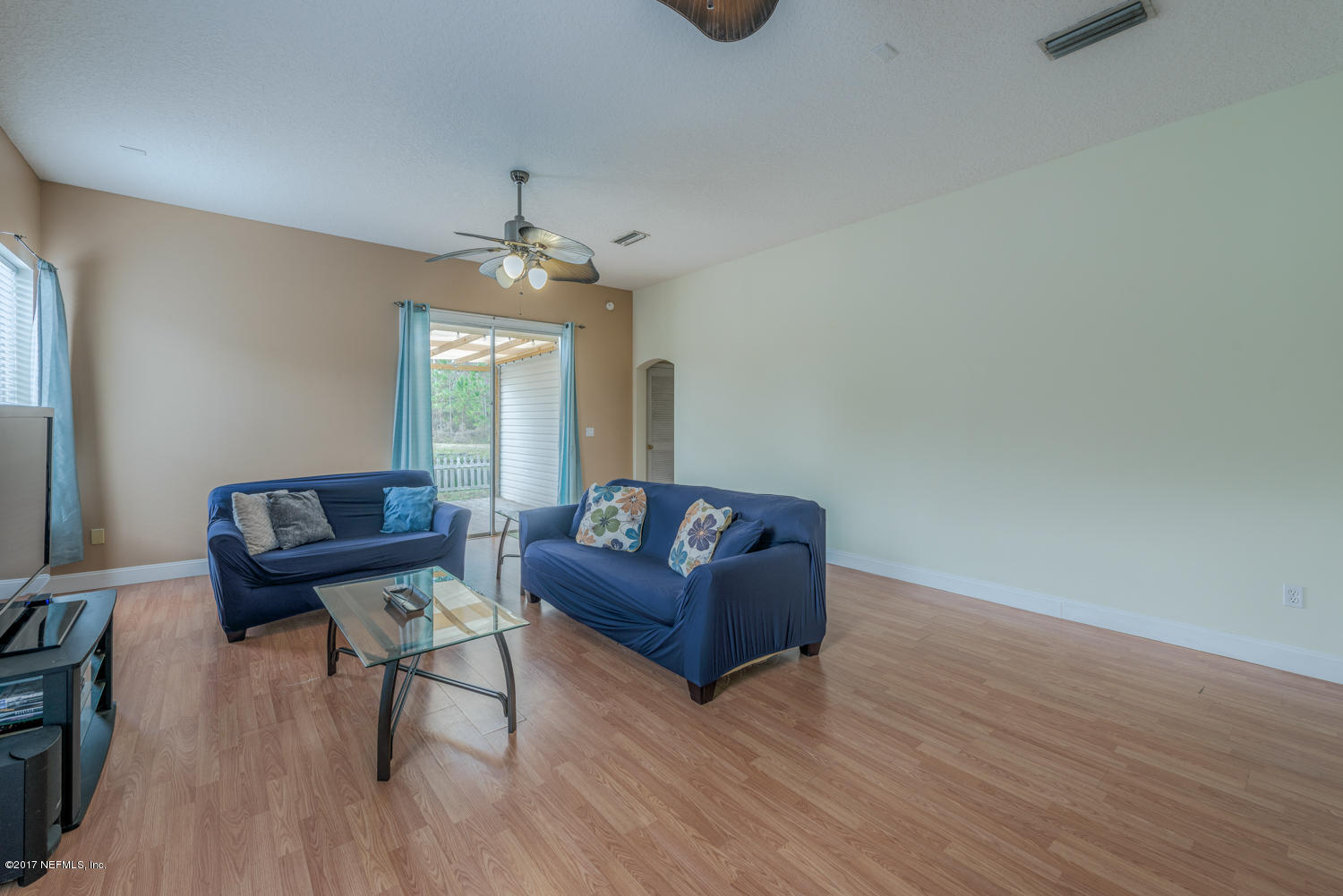 9170 Raptor Drive Jacksonville, FL 32221 - Photo 17 of 31 a living room with furniture and a chandelier