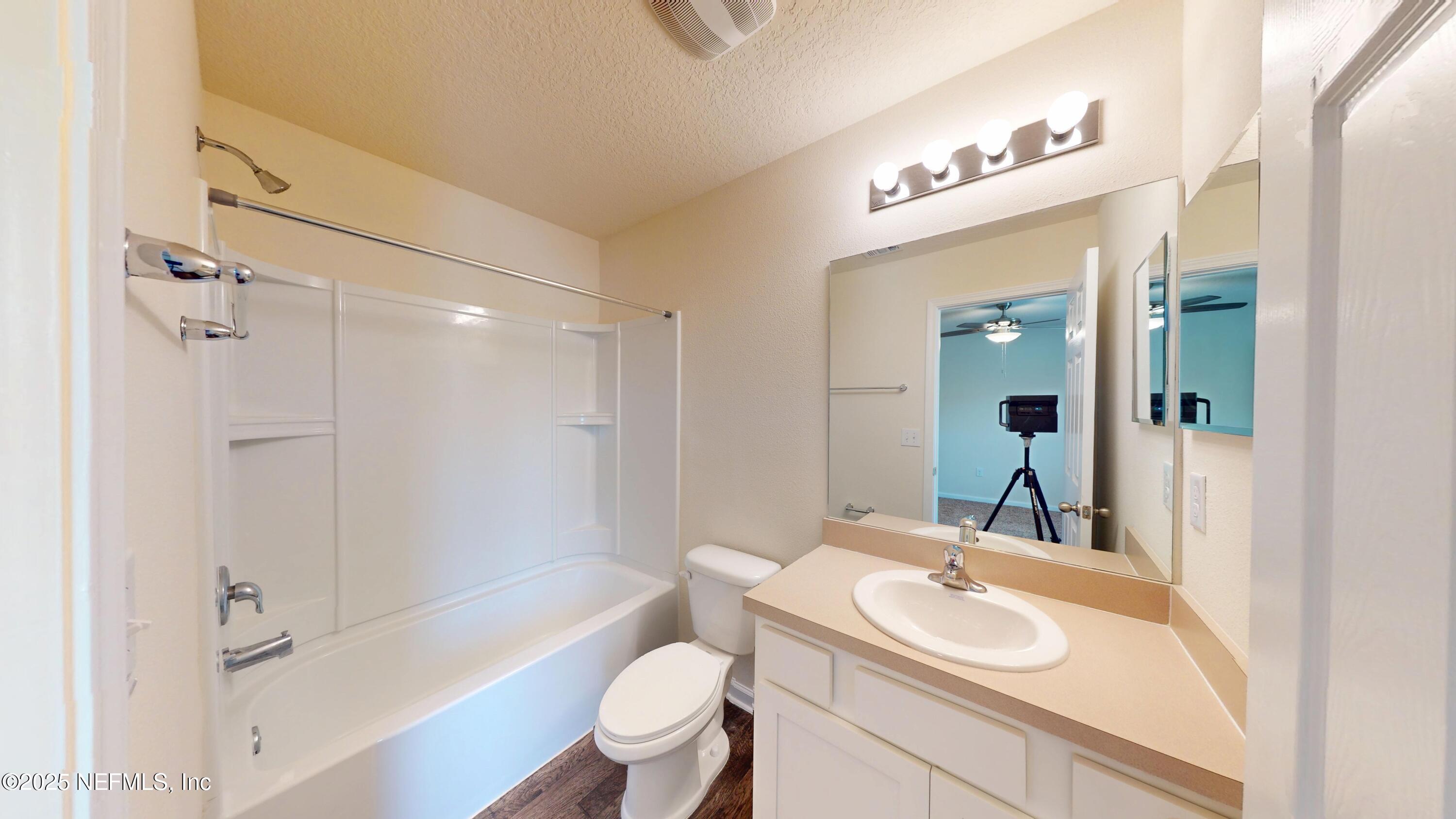 93 Scotch Pebble Drive Jacksonville, FL 32259 - Photo 16 of 27 a bathroom with a sink a toilet a mirror a bathtub and shower