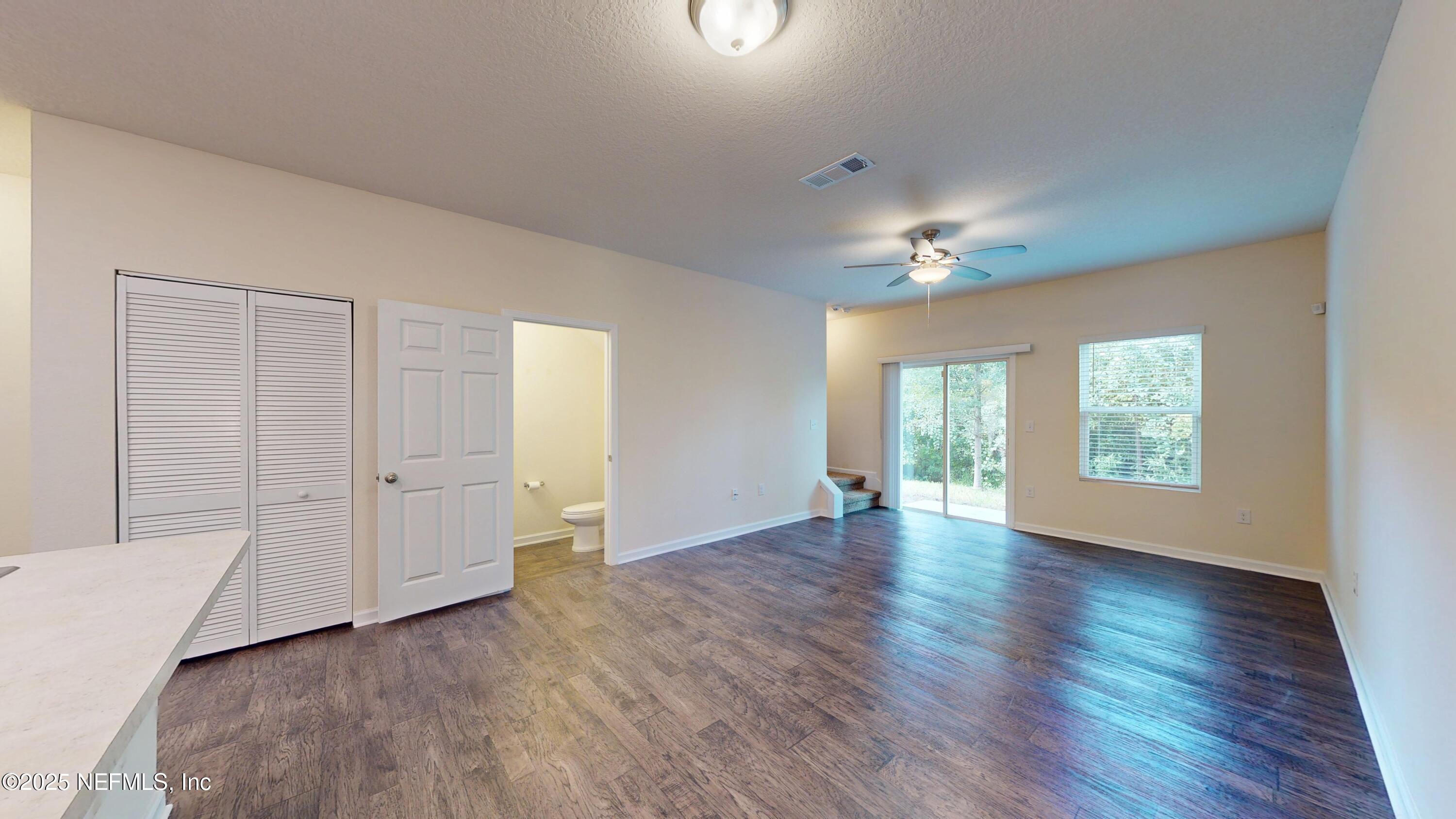 93 Scotch Pebble Drive Jacksonville, FL 32259 - Photo 20 of 27 an empty room with wooden floor and windows