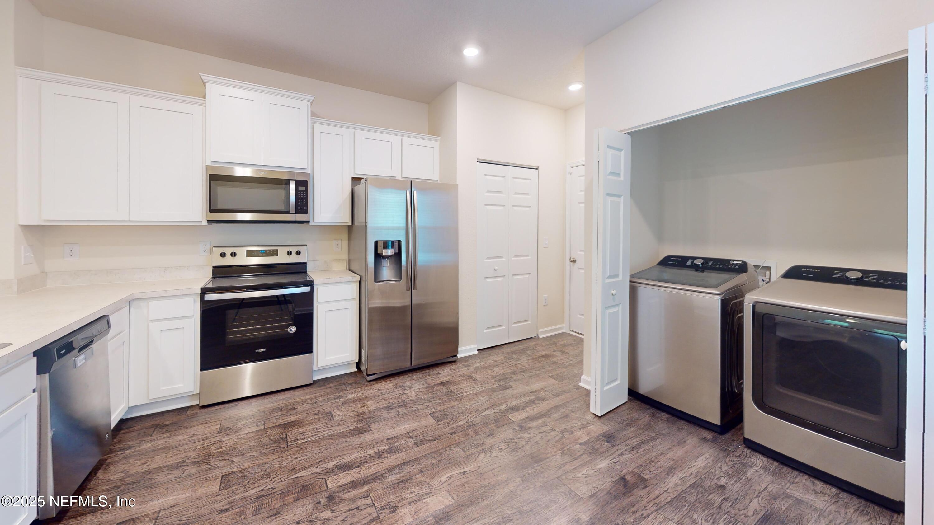 93 Scotch Pebble Drive Jacksonville, FL 32259 - Photo 2 of 27 a kitchen with a refrigerator stove and microwave
