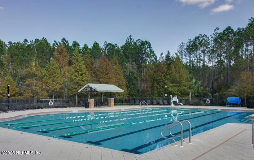 93 Scotch Pebble Drive Jacksonville, FL 32259 - Photo 26 of 27 a view of a garden with a bench in the park