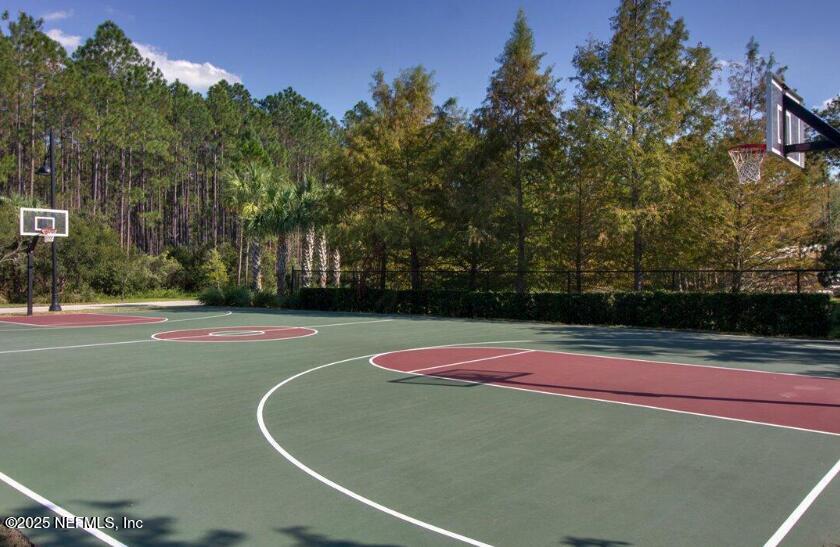93 Scotch Pebble Drive Jacksonville, FL 32259 - Photo 27 of 27 a view of tennis ground with large trees
