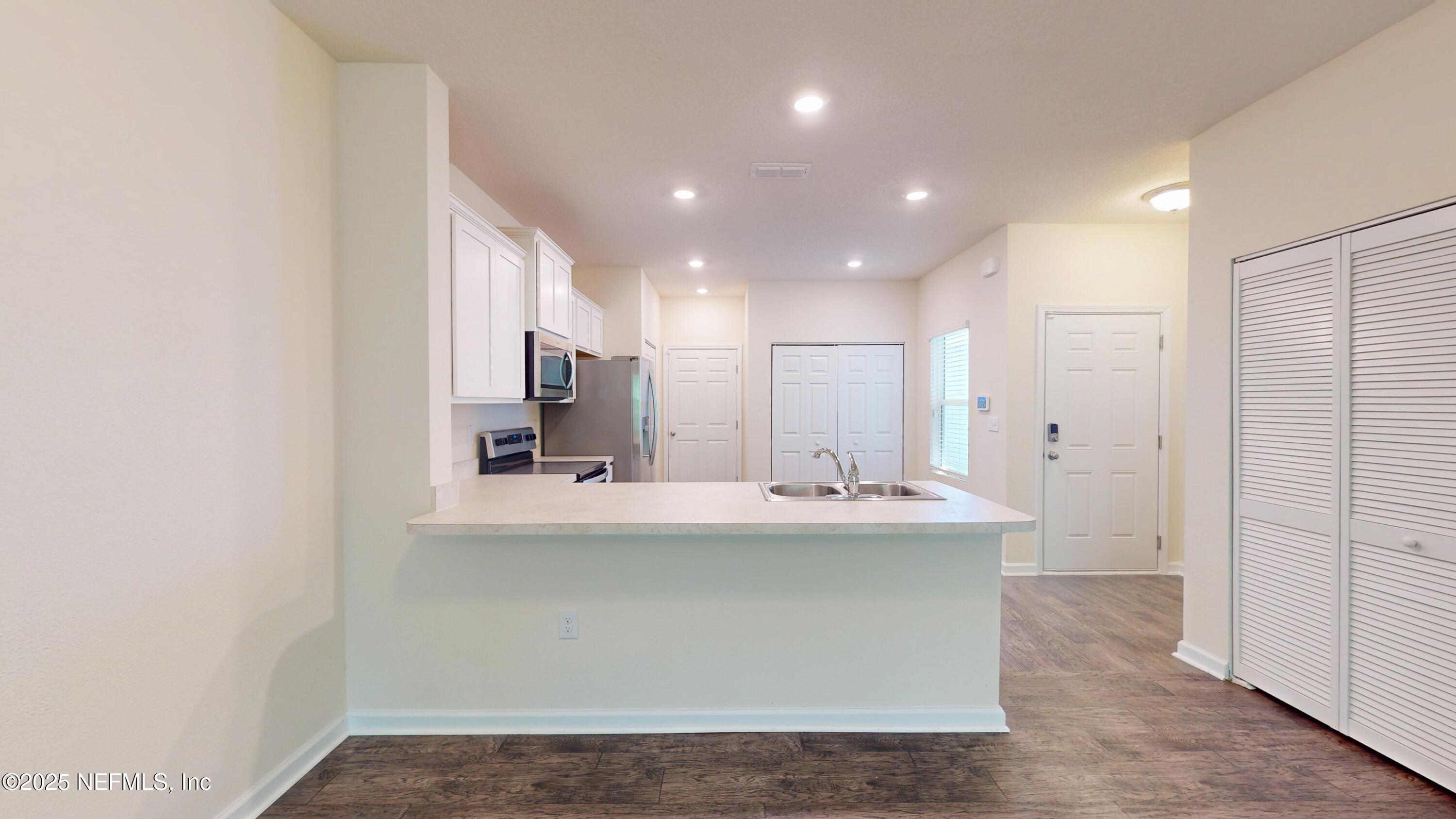 93 Scotch Pebble Drive Jacksonville, FL 32259 - Photo 3 of 27 a kitchen with kitchen island a sink stainless steel appliances and cabinets