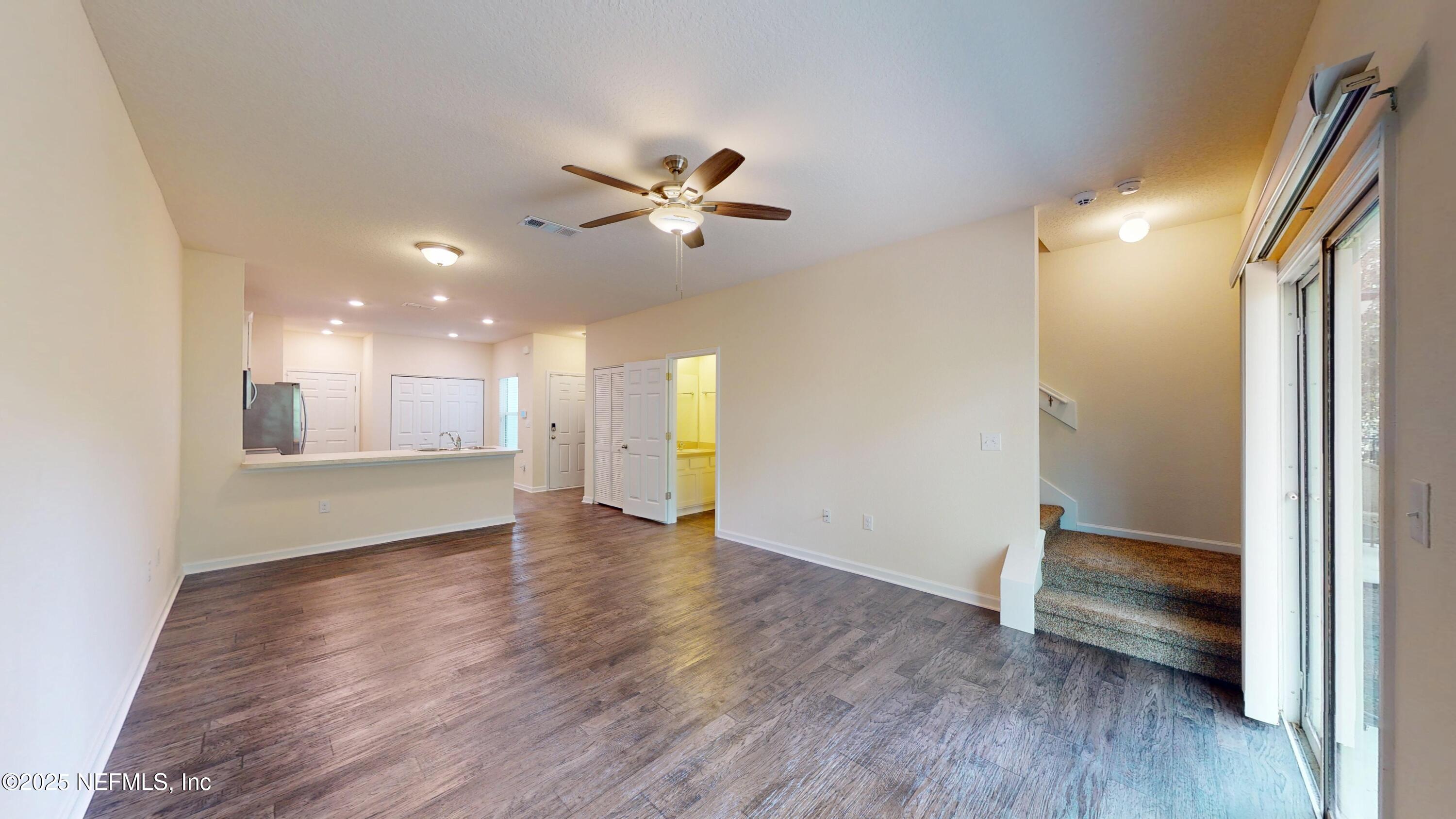 93 Scotch Pebble Drive Jacksonville, FL 32259 - Photo 8 of 27 wooden floor in an empty room with a window