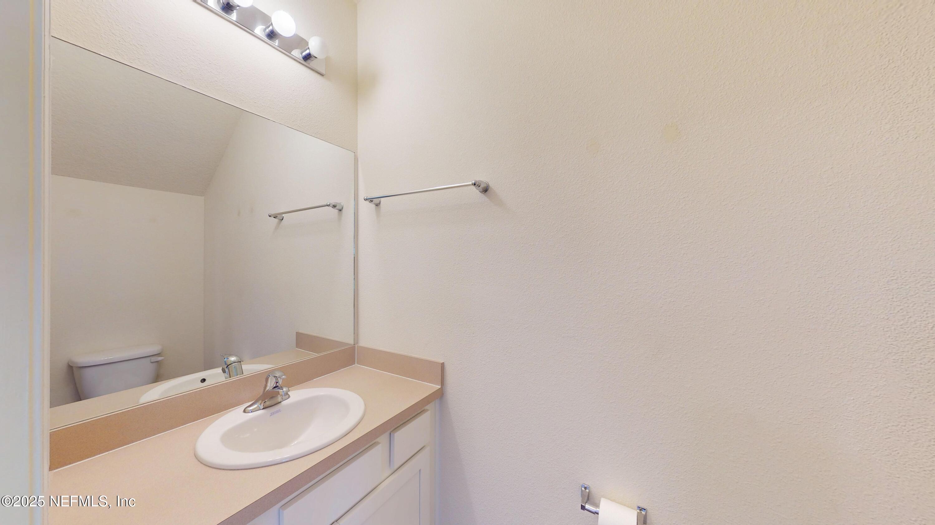 93 Scotch Pebble Drive Jacksonville, FL 32259 - Photo 10 of 27 a bathroom with a sink and a mirror
