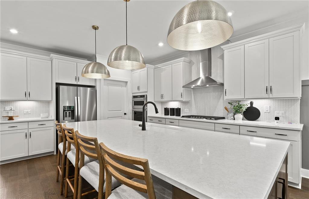 319 Canoe Place Villa Rica, GA 30180 - Photo 14 of 38 a kitchen with kitchen island a stove a chandelier and a refrigerator