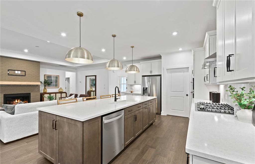 319 Canoe Place Villa Rica, GA 30180 - Photo 15 of 38 a large kitchen with stainless steel appliances a large center island attached withe living room