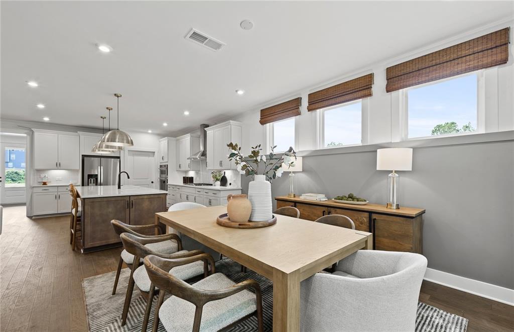 319 Canoe Place Villa Rica, GA 30180 - Photo 20 of 38 a kitchen with a table chairs sink and cabinets