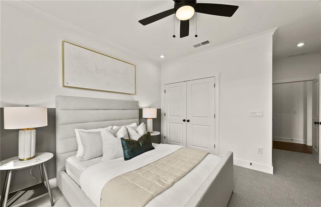 319 Canoe Place Villa Rica, GA 30180 - Photo 22 of 38 a bedroom with a bed and a lamp on table