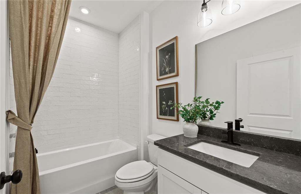 319 Canoe Place Villa Rica, GA 30180 - Photo 24 of 38 a bathroom with a sink a toilet a tub and shower
