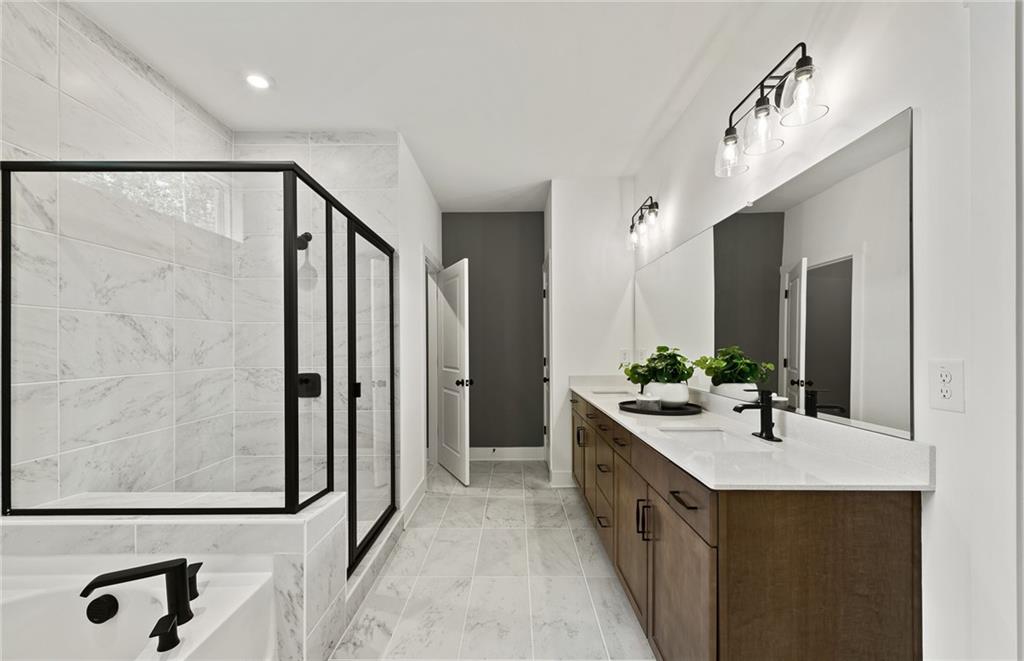 319 Canoe Place Villa Rica, GA 30180 - Photo 29 of 38 a bathroom with a double vanity sink a mirror and a shower