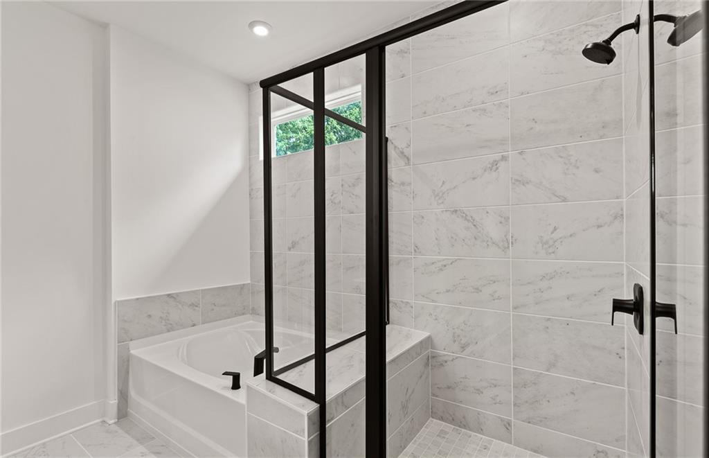 319 Canoe Place Villa Rica, GA 30180 - Photo 30 of 38 a bathroom with a tub and shower