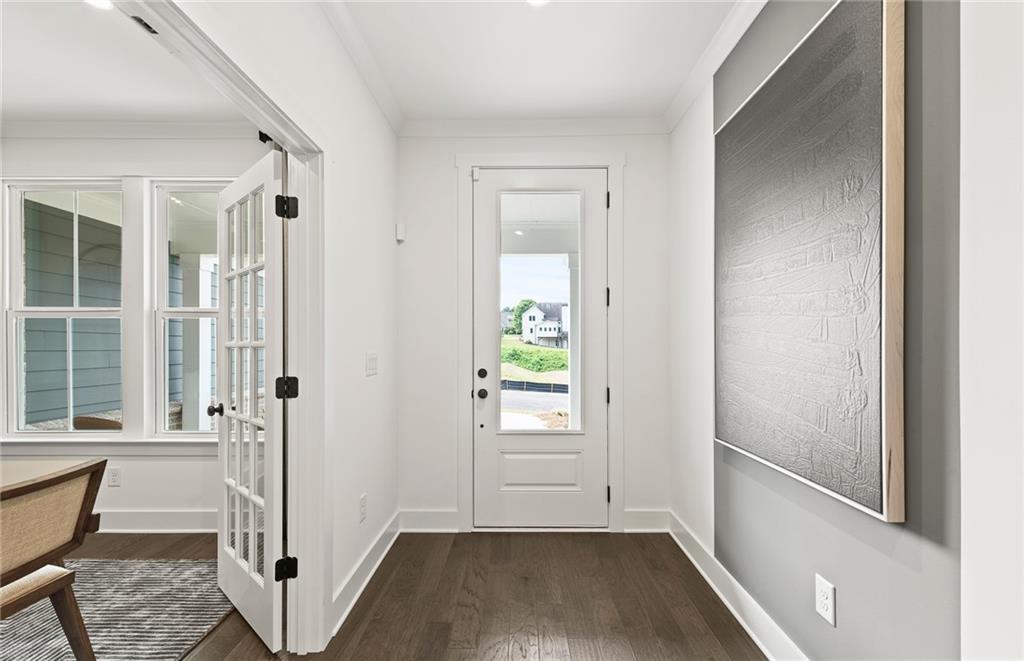 319 Canoe Place Villa Rica, GA 30180 - Photo 5 of 38 a view of a hallway with wooden floor and a bathroom
