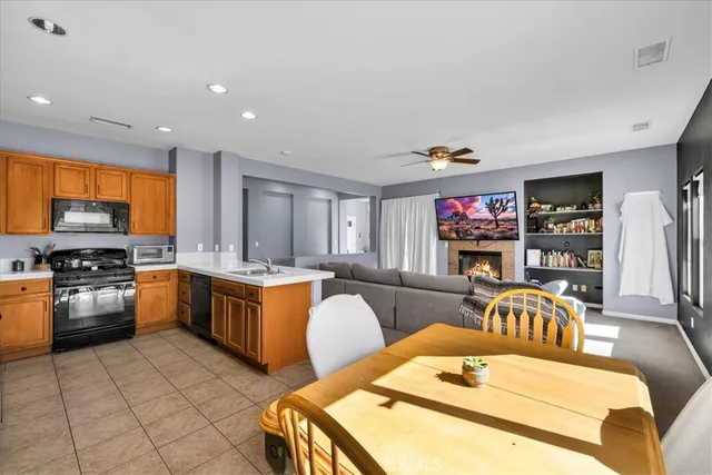 a kitchen with stainless steel appliances granite countertop a sink and a refrigerator