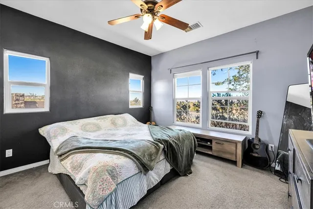 a bed sitting in a bedroom next to a window