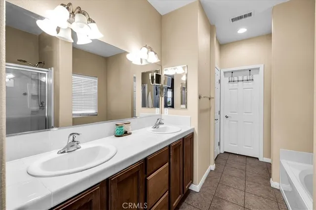 a bathroom with a double vanity sink and a mirror