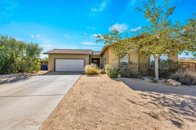 a front view of a house with a yard and a garage