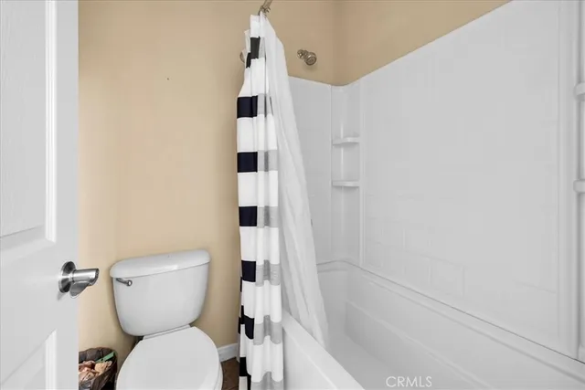 a white toilet sitting next to a bathroom sink