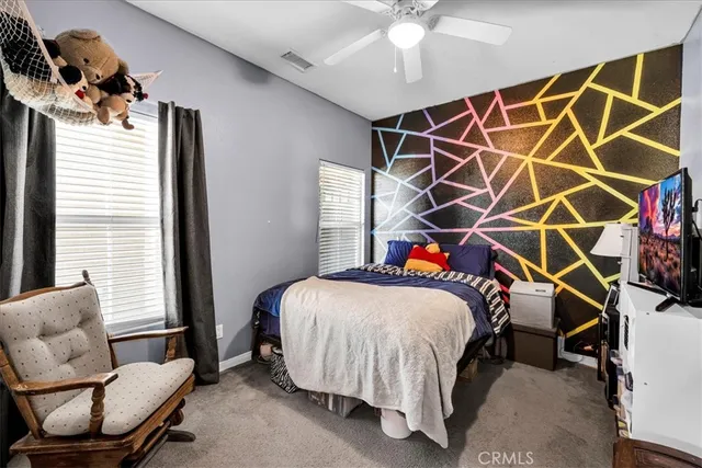 a bedroom with a bed and a chair