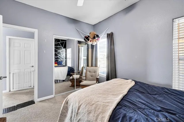 a bedroom with a bed and a large mirror