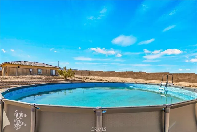 a view of a house with a wooden fence