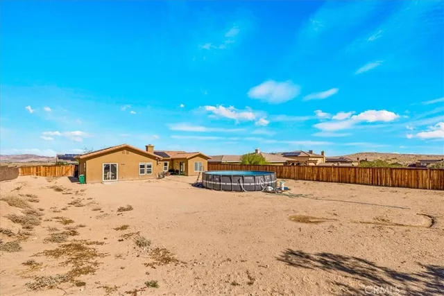 a view of a patio with chairs and floor to ceiling window