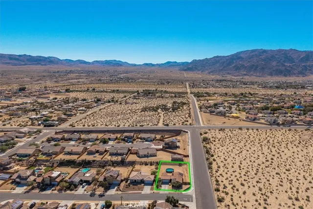 an aerial view of a house with a swimming pool