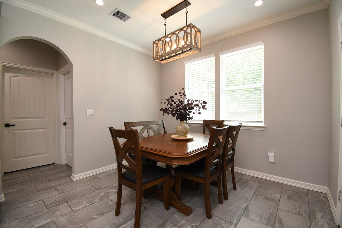 2406 Hummingbird Street New Caney, TX 77357 - Photo 15 of 40 a dining room with furniture a chandelier and window