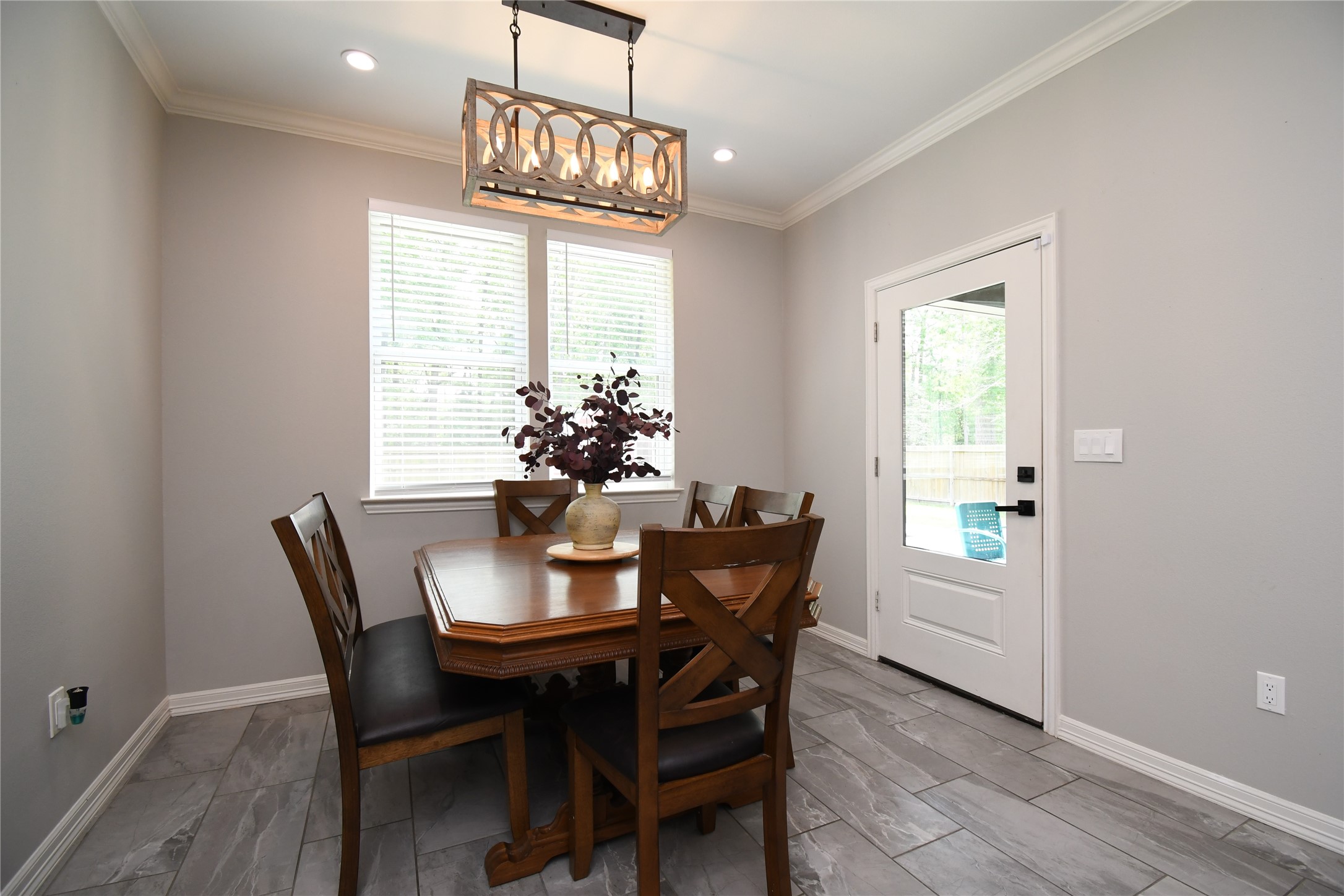 2406 Hummingbird Street New Caney, TX 77357 - Photo 16 of 40 a dining room with furniture a chandelier and wooden floor