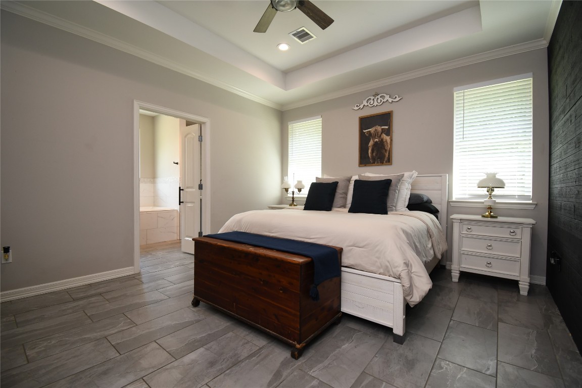 2406 Hummingbird Street New Caney, TX 77357 - Photo 18 of 40 a bedroom with a bed and a ceiling fan