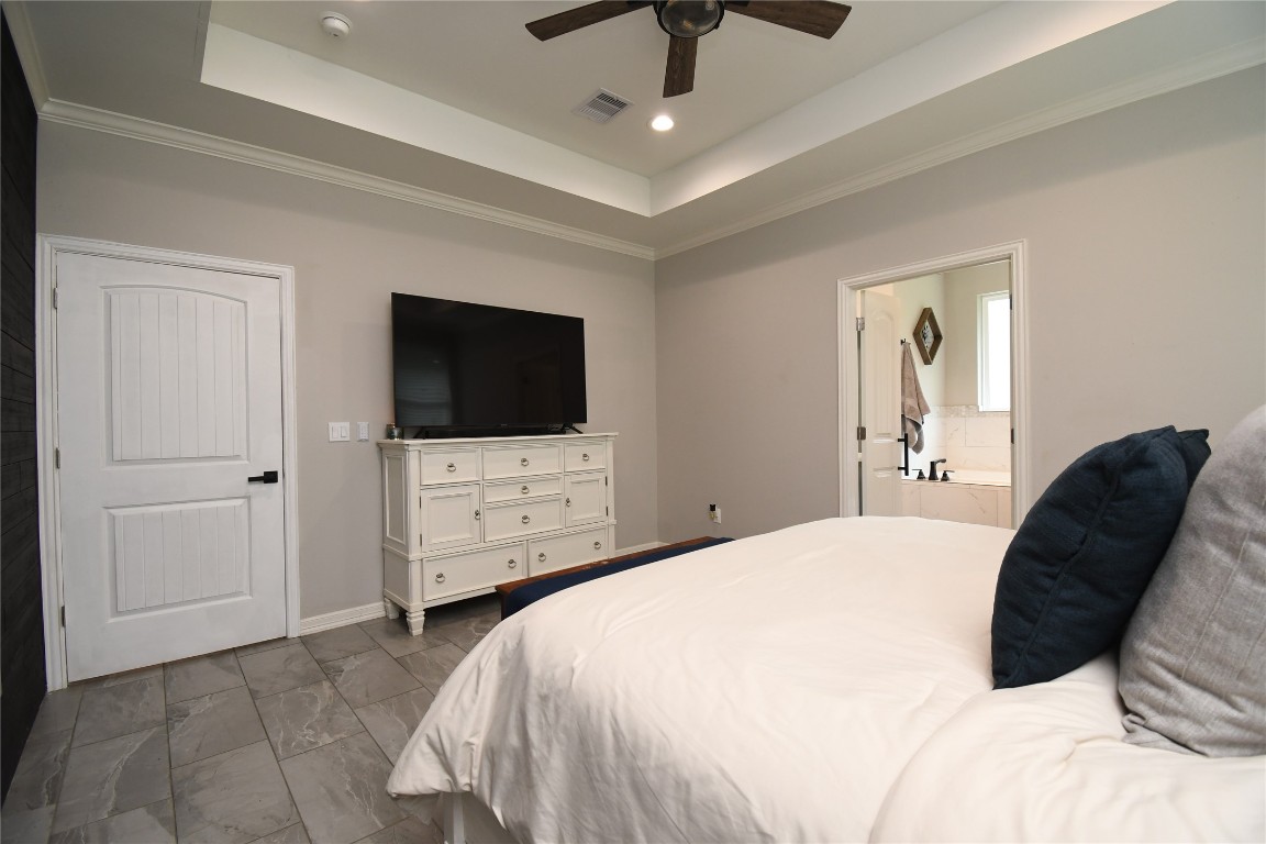 2406 Hummingbird Street New Caney, TX 77357 - Photo 19 of 40 a bedroom with a bed tv and window