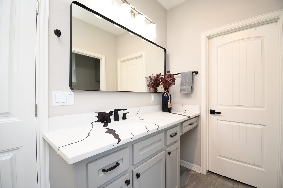 2406 Hummingbird Street New Caney, TX 77357 - Photo 20 of 40 a bathroom with a sink and a mirror