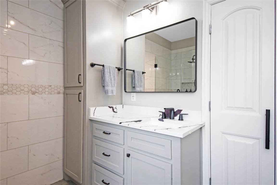 2406 Hummingbird Street New Caney, TX 77357 - Photo 21 of 40 a bathroom with a double vanity sink mirror and