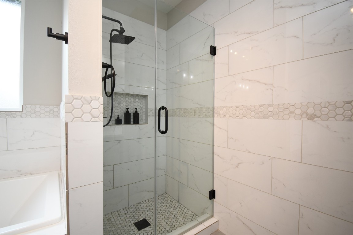 2406 Hummingbird Street New Caney, TX 77357 - Photo 23 of 40 a bathroom with a shower and a sink