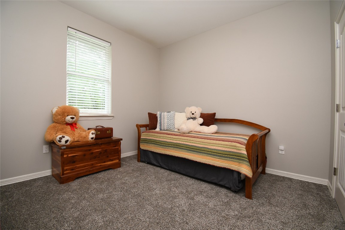 2406 Hummingbird Street New Caney, TX 77357 - Photo 28 of 40 a bedroom with a bed and a window