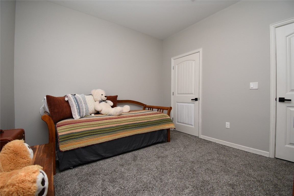2406 Hummingbird Street New Caney, TX 77357 - Photo 29 of 40 a spacious bedroom with a bed and a window