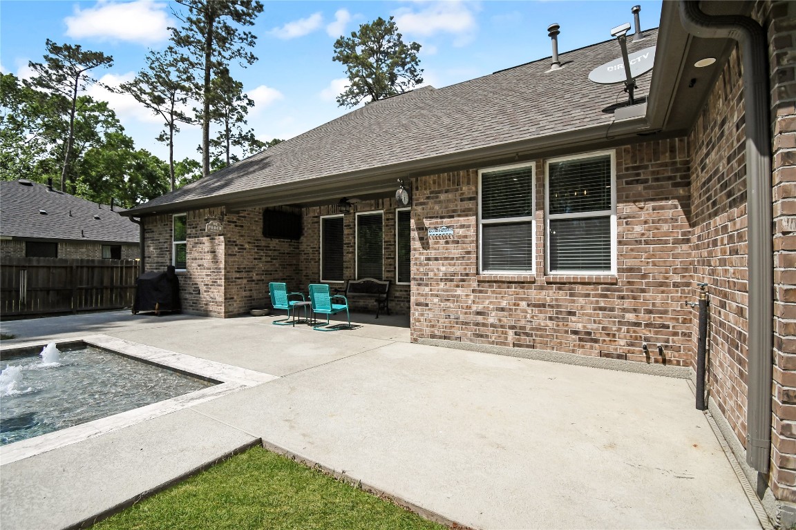 2406 Hummingbird Street New Caney, TX 77357 - Photo 35 of 40 a front view of a house with garden