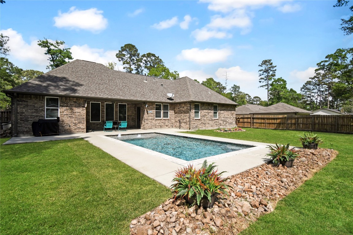 2406 Hummingbird Street New Caney, TX 77357 - Photo 36 of 40 a front view of a house with garden