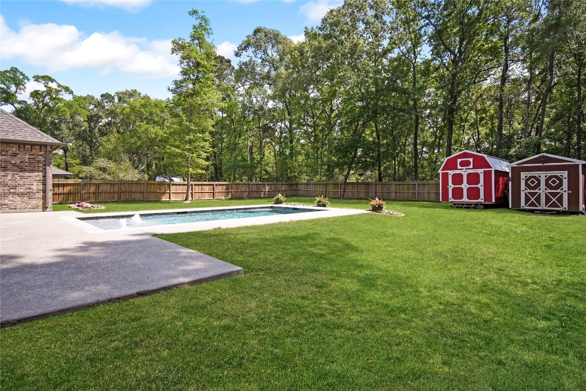 2406 Hummingbird Street New Caney, TX 77357 - Photo 37 of 40 a view of outdoor space with garden and trees
