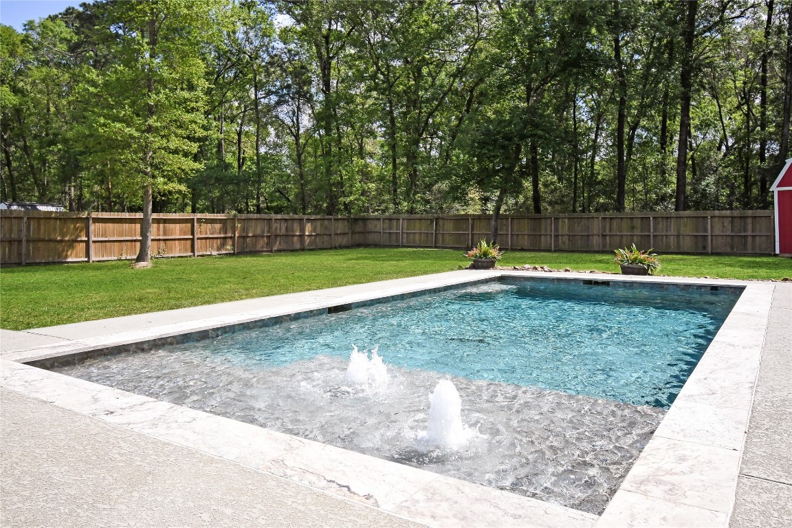 2406 Hummingbird Street New Caney, TX 77357 - Photo 4 of 40 a view of a backyard with large trees