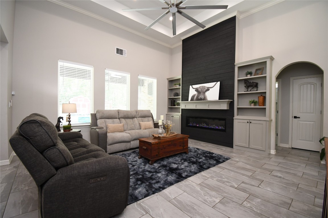 2406 Hummingbird Street New Caney, TX 77357 - Photo 5 of 40 a living room with furniture a chandelier and a window