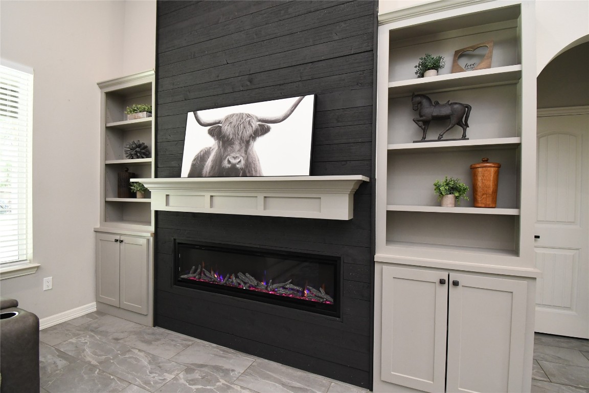 2406 Hummingbird Street New Caney, TX 77357 - Photo 6 of 40 a living room with a fireplace and a walk in closet