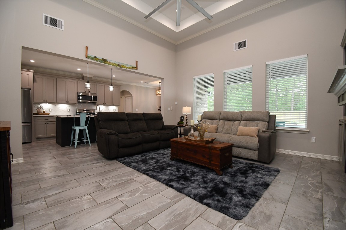 2406 Hummingbird Street New Caney, TX 77357 - Photo 7 of 40 a living room with furniture a large window and a table