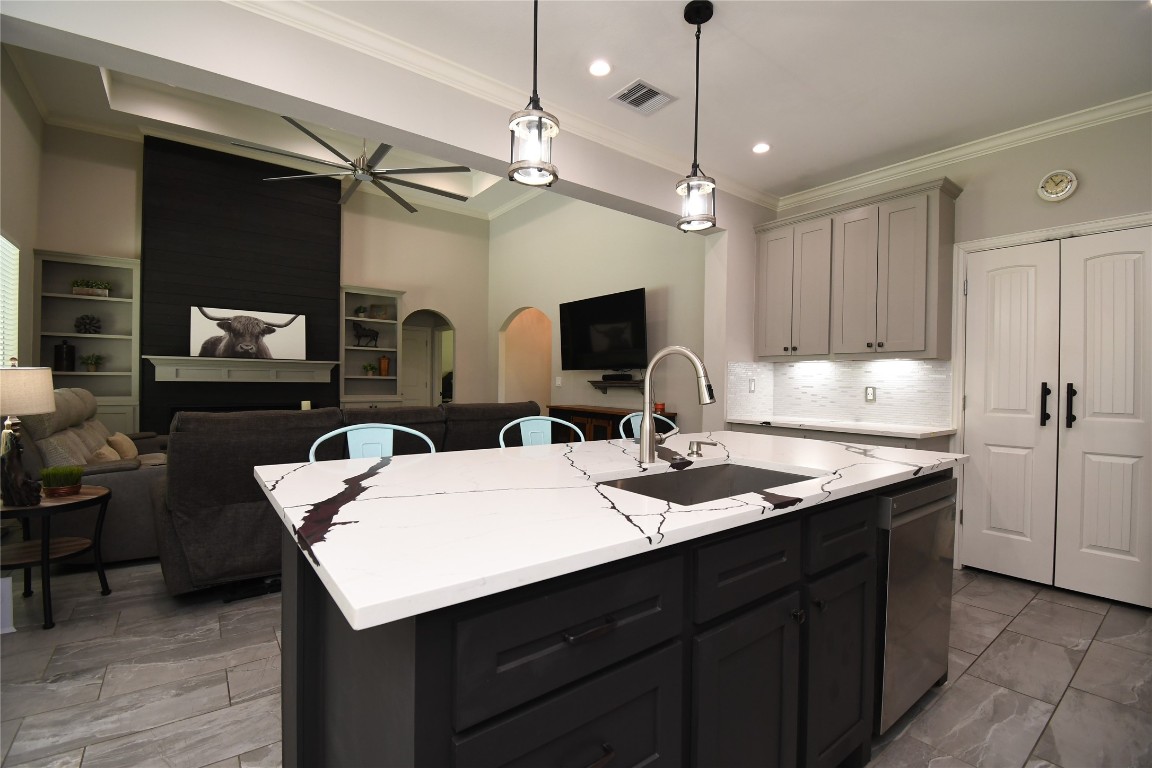 2406 Hummingbird Street New Caney, TX 77357 - Photo 9 of 40 a kitchen with a sink a counter space and wooden floor