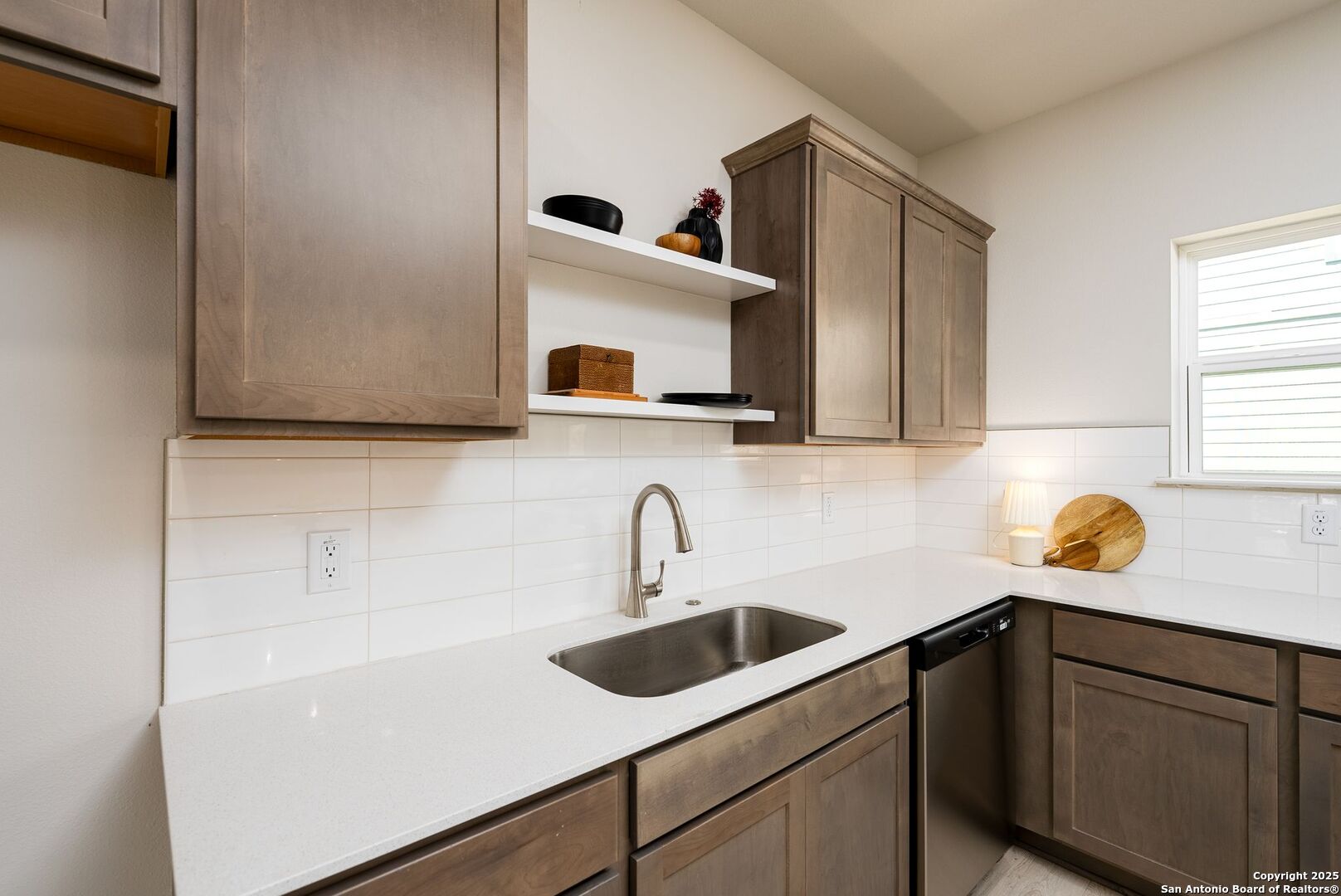 419 Ira Avenue, Unit 1102 San Antonio, TX 78209 - Photo 13 of 28 a kitchen with a sink cabinets and a window
