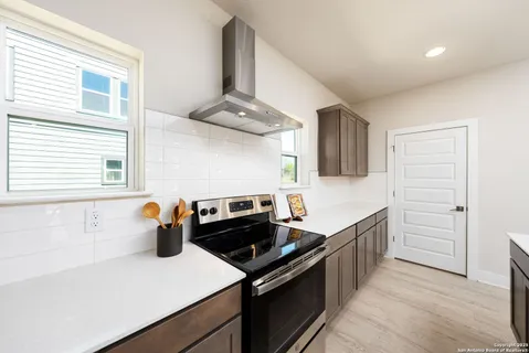a kitchen with stainless steel appliances a stove a sink and a refrigerator