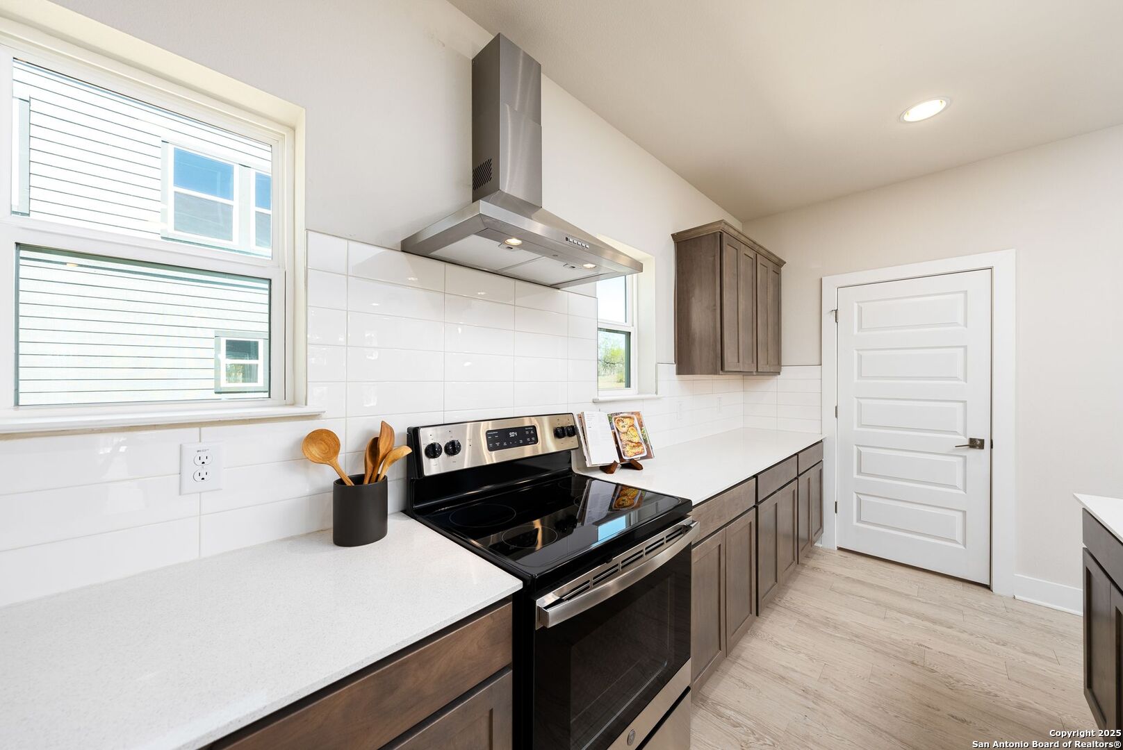 419 Ira Avenue, Unit 1102 San Antonio, TX 78209 - Photo 14 of 28 a kitchen with stainless steel appliances a stove a sink and a refrigerator