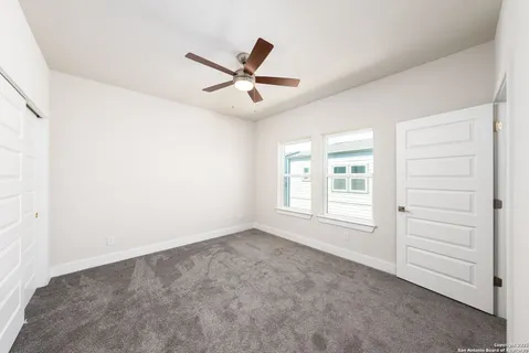 a view of empty room with ceiling fan