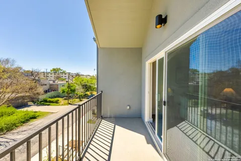 a view of balcony with wooden floor